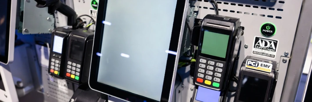 Hardware components and payment terminals of a mid-range interactive shopping kiosk highlighting hidden deployment costs like PCI EMV certification and ADA compliance.